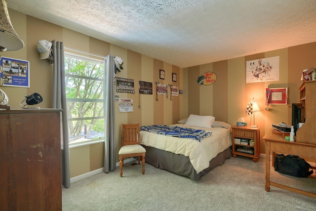 carpeted bedroom with a textured ceiling, multiple windows, and baseboards