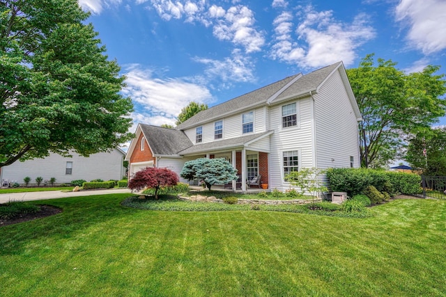 view of front of home with covered porch, fence, a front lawn, concrete driveway, and an attached garage