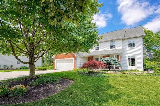 view of front of house with concrete driveway, a front yard, and an attached garage