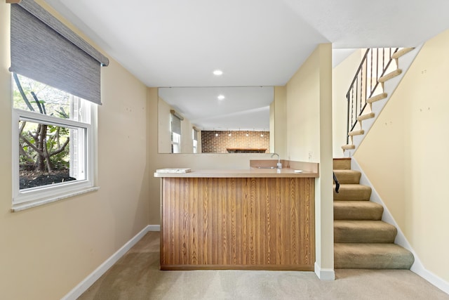 bar with light carpet, baseboards, stairway, recessed lighting, and a sink