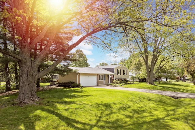 split level home with a garage, driveway, and a front yard