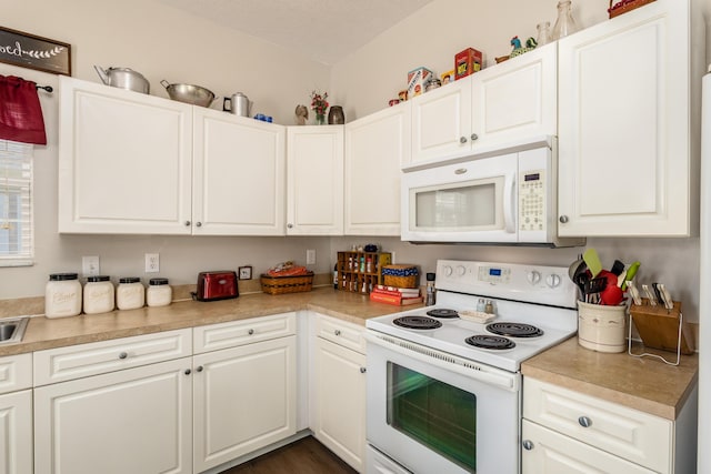 kitchen with white cabinetry, white appliances, and light countertops