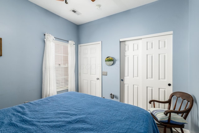 bedroom with a closet, visible vents, and ceiling fan