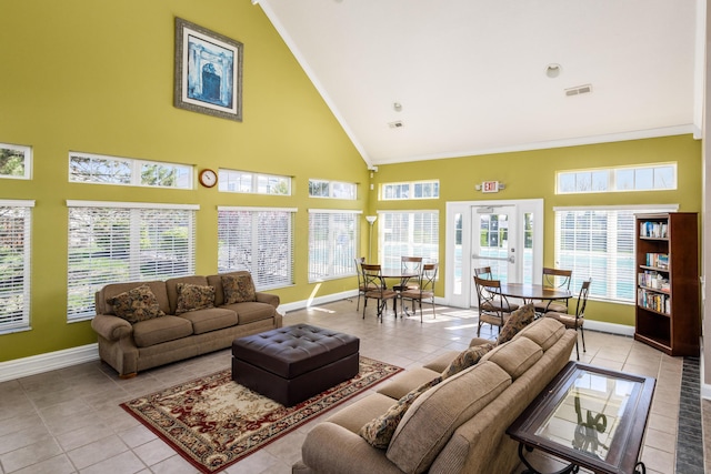 living room featuring baseboards, visible vents, tile patterned flooring, crown molding, and high vaulted ceiling