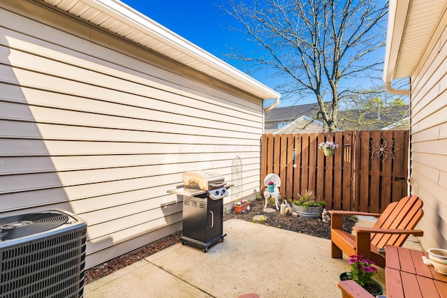 view of patio / terrace with fence, grilling area, and central AC