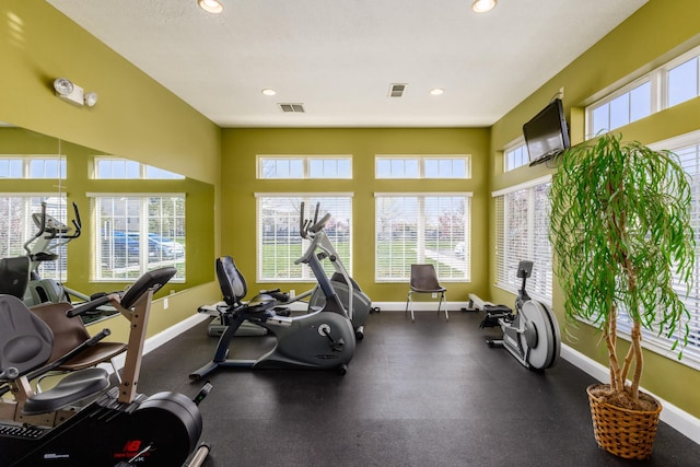 workout area featuring baseboards, visible vents, and recessed lighting