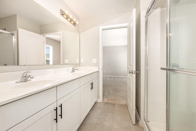bathroom with double vanity, a sink, tile patterned floors, and a shower stall