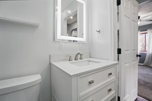 bathroom featuring toilet and vanity