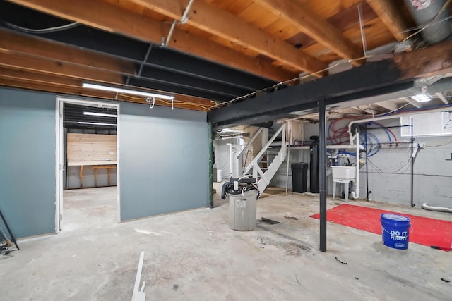 unfinished below grade area with a sink and stairs