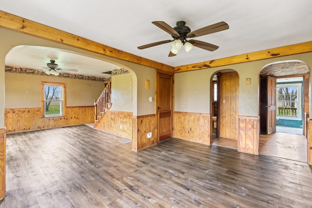 720 Green Cook Rd, Sunbury, OH 43074 - unfurnished living room featuring wood finished floors, a wainscoted wall, wooden walls, and a ceiling fan