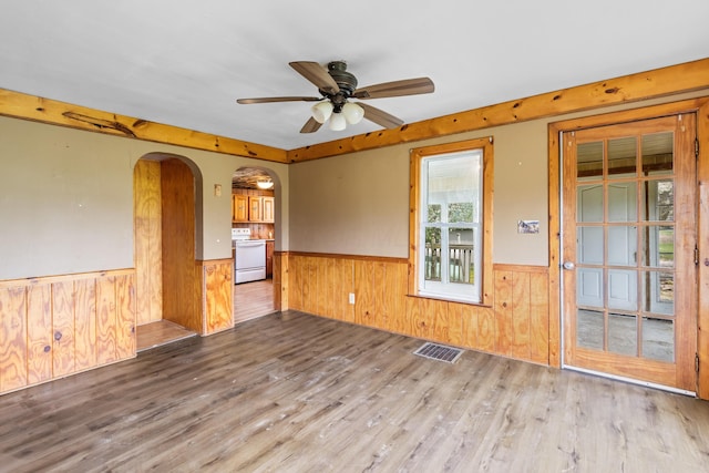 720 Green Cook Rd, Sunbury, OH 43074 - unfurnished room with arched walkways, wood finished floors, visible vents, and a wainscoted wall