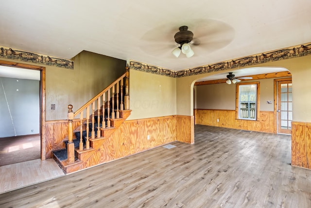 720 Green Cook Rd, Sunbury, OH 43074 - unfurnished room with wainscoting, arched walkways, a ceiling fan, and wood finished floors