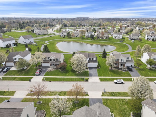 drone / aerial view featuring a water view and a residential view