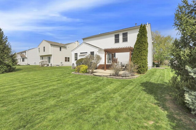 back of house featuring a lawn, a pergola, and a patio area