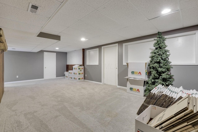 finished below grade area with recessed lighting, visible vents, carpet floors, baseboards, and a paneled ceiling