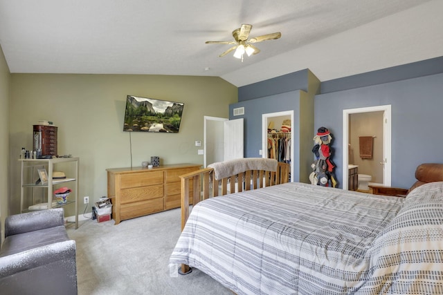 bedroom with vaulted ceiling, visible vents, a spacious closet, light colored carpet, and a closet