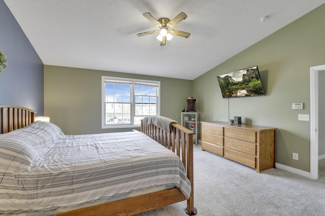 bedroom featuring ceiling fan, light carpet, lofted ceiling, and baseboards