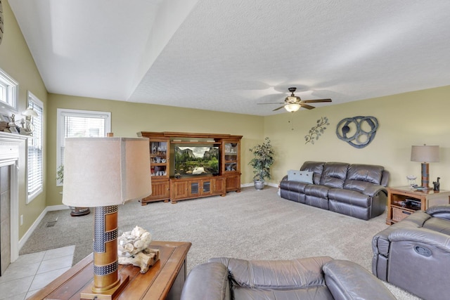 living area with light carpet, a ceiling fan, and baseboards