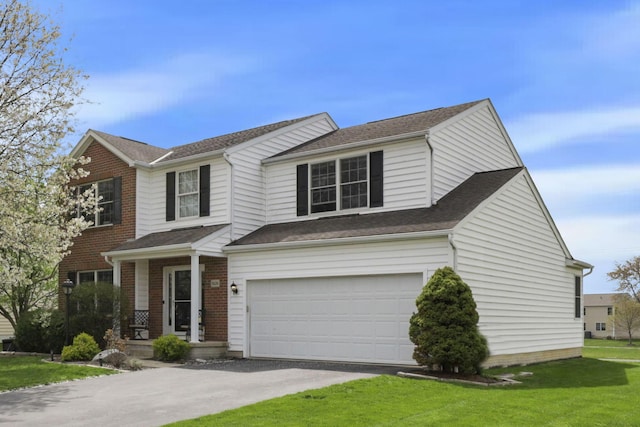 traditional-style house with brick siding, a front lawn, driveway, and a garage