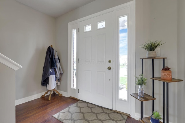 entryway with wood finished floors, a healthy amount of sunlight, and baseboards