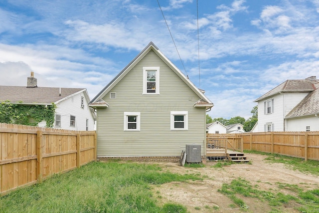940 3rd St, Logan, OH 43138 - rear view of property featuring a fenced backyard, a wooden deck, and central AC