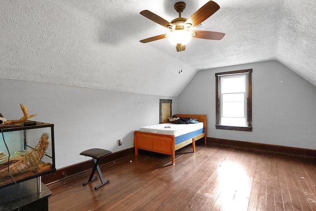 940 3rd St, Logan, OH 43138 - bedroom with a textured ceiling, baseboards, wood-type flooring, vaulted ceiling, and ceiling fan