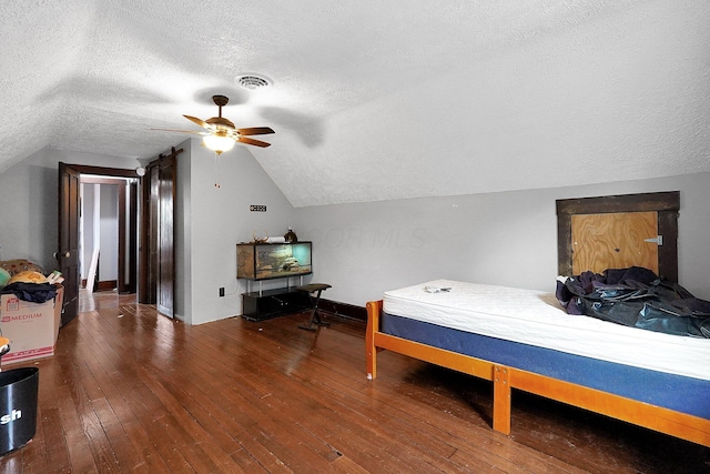 940 3rd St, Logan, OH 43138 - bedroom with a textured ceiling, hardwood / wood-style flooring, vaulted ceiling, baseboards, and ceiling fan