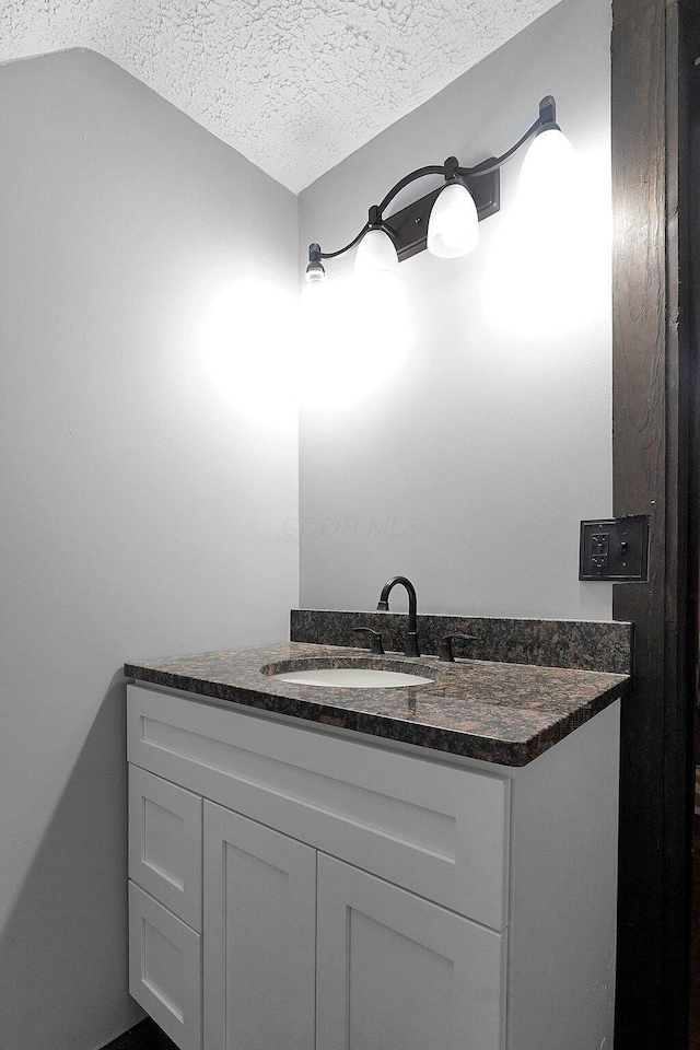 940 3rd St, Logan, OH 43138 - bathroom with a textured ceiling and vanity