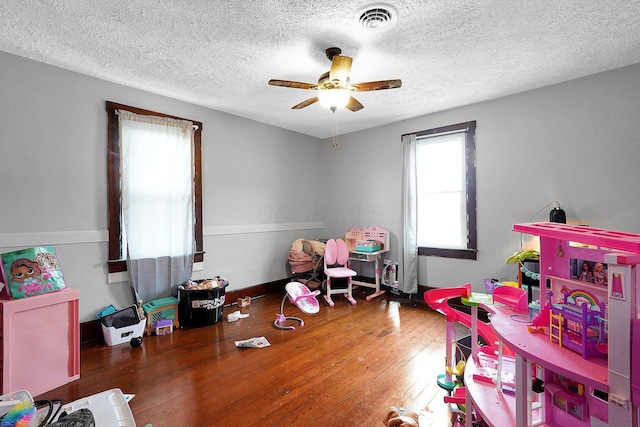 940 3rd St, Logan, OH 43138 - playroom featuring ceiling fan, wood finished floors, and a textured ceiling