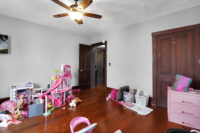 940 3rd St, Logan, OH 43138 - rec room with hardwood / wood-style floors, ceiling fan, a textured ceiling, and baseboards