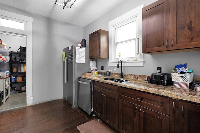 940 3rd St, Logan, OH 43138 - kitchen with stainless steel dishwasher, a sink, dark wood finished floors, and light stone countertops