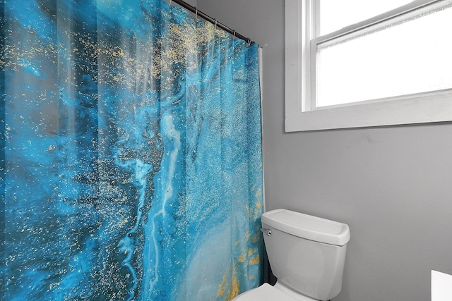 940 3rd St, Logan, OH 43138 - bathroom with toilet and a shower with shower curtain