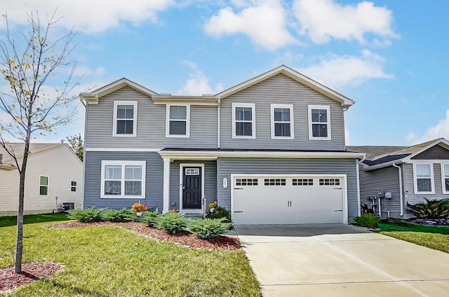 view of front of property with a front lawn, driveway, central AC unit, and a garage