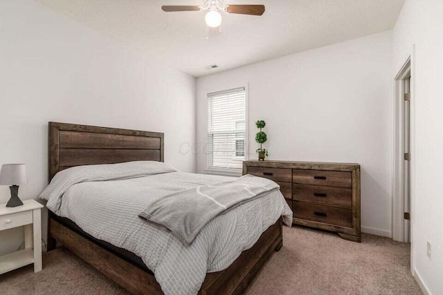 bedroom with visible vents, carpet flooring, baseboards, and a ceiling fan