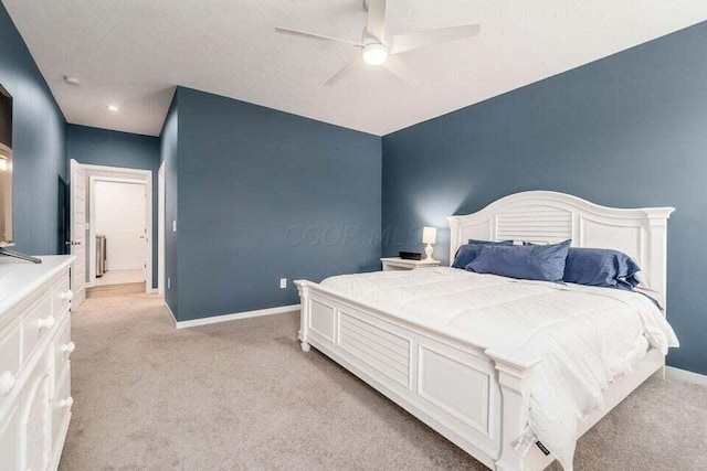 bedroom featuring a ceiling fan, baseboards, and light carpet