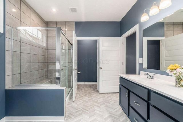 full bath featuring baseboards, vanity, and a stall shower