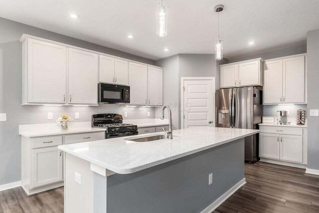 kitchen with range with gas stovetop, a sink, black microwave, stainless steel refrigerator with ice dispenser, and dark wood-style flooring