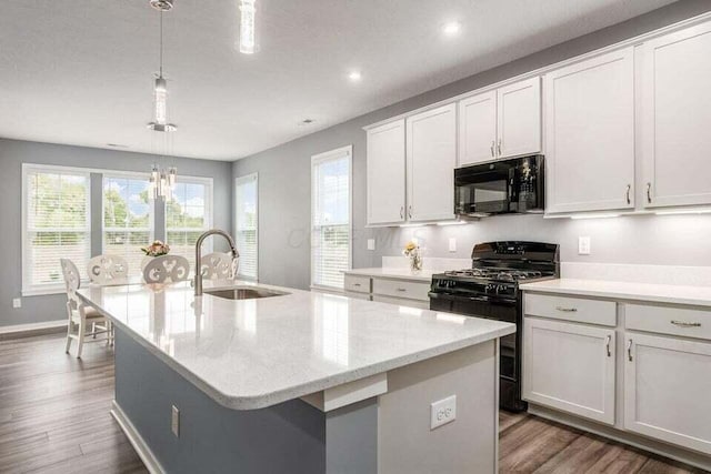 kitchen featuring a sink, dark wood-style flooring, recessed lighting, an island with sink, and black appliances