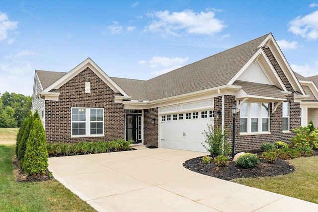 view of front of house featuring an attached garage, brick siding, roof with shingles, and concrete driveway