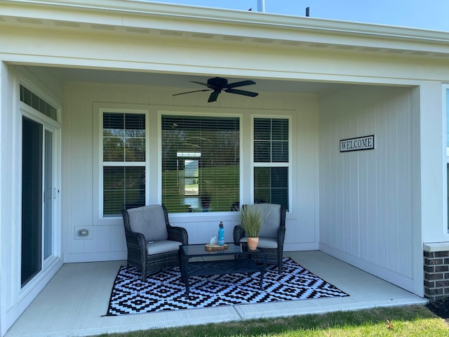 entrance to property with a ceiling fan and covered porch