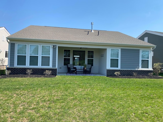 back of house with a lawn, brick siding, a patio, and an outdoor hangout area