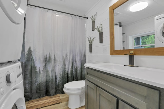 62579 Dunkle Creek Rd, Mcarthur, OH 45651 - bathroom with wood finished floors, vanity, toilet, stacked washer and clothes dryer, and a shower with shower curtain