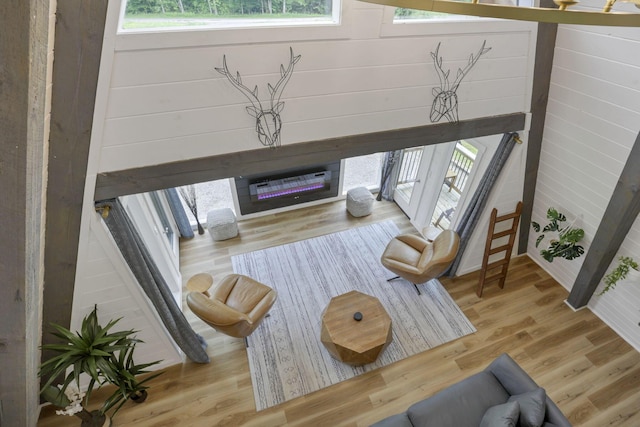 62579 Dunkle Creek Rd, Mcarthur, OH 45651 - living room featuring a glass covered fireplace, a healthy amount of sunlight, and wood finished floors