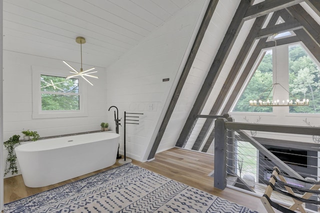 62579 Dunkle Creek Rd, Mcarthur, OH 45651 - full bathroom with a freestanding bath, a notable chandelier, wood finished floors, and vaulted ceiling