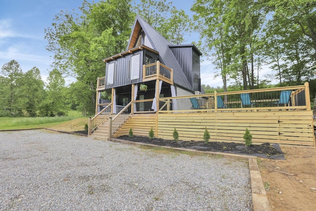 62579 Dunkle Creek Rd, Mcarthur, OH 45651 - view of front facade with board and batten siding, stairway, and a balcony