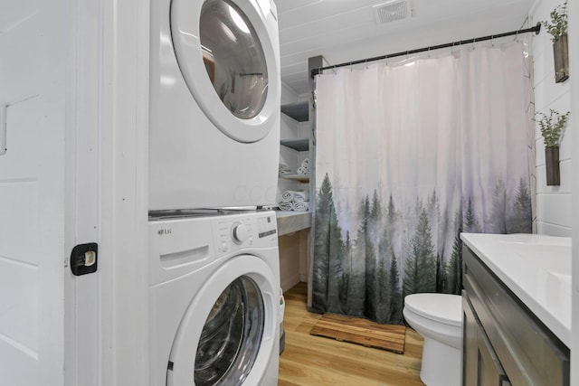 62579 Dunkle Creek Rd, Mcarthur, OH 45651 - laundry area featuring stacked washing maching and dryer, light wood-style floors, laundry area, and visible vents