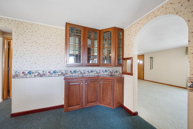 bar featuring arched walkways, wallpapered walls, carpet flooring, and crown molding