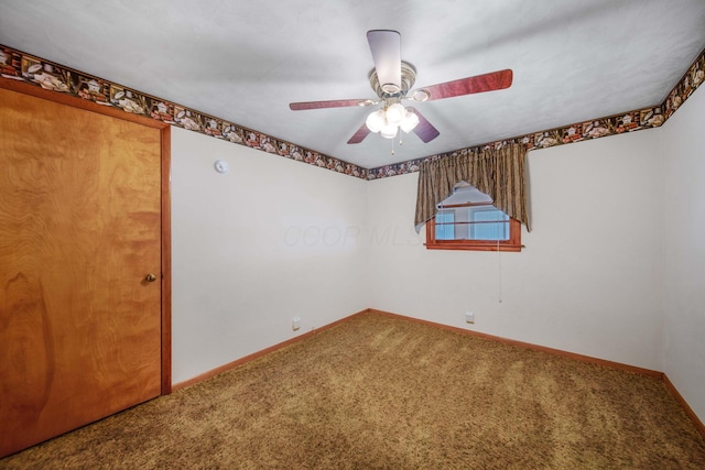 unfurnished room with baseboards, a ceiling fan, and carpet flooring