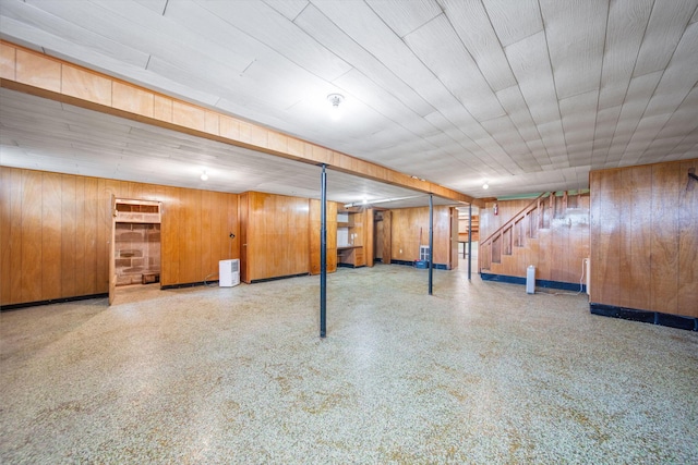 finished basement with stairway and wooden walls