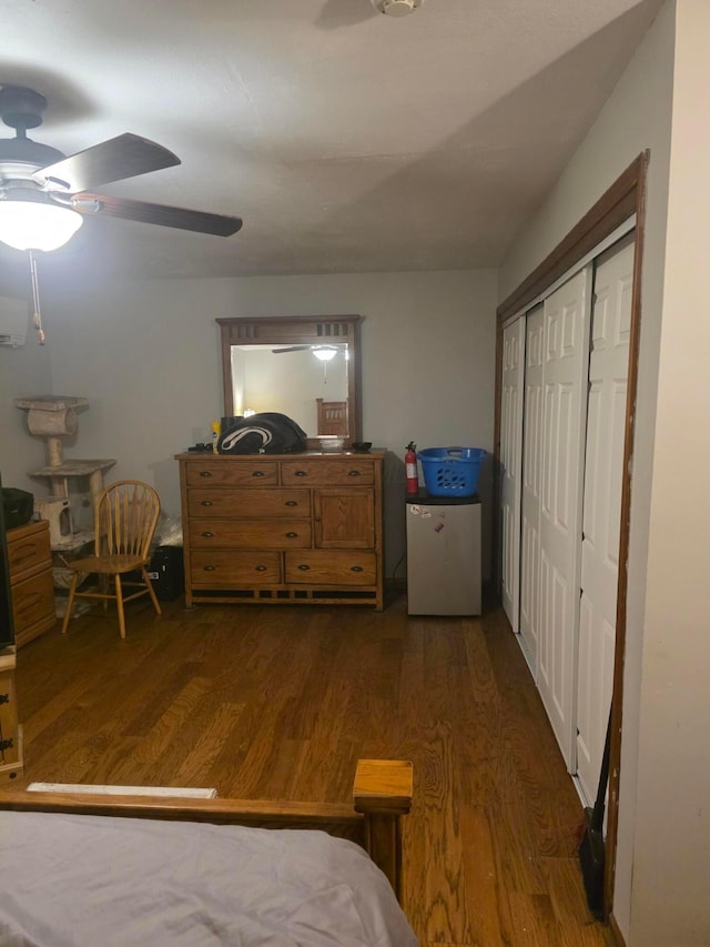 196 Whitethorne Ave, Columbus, OH 43223 - bedroom featuring freestanding refrigerator, dark wood-style flooring, a closet, a ceiling fan, and an AC wall unit
